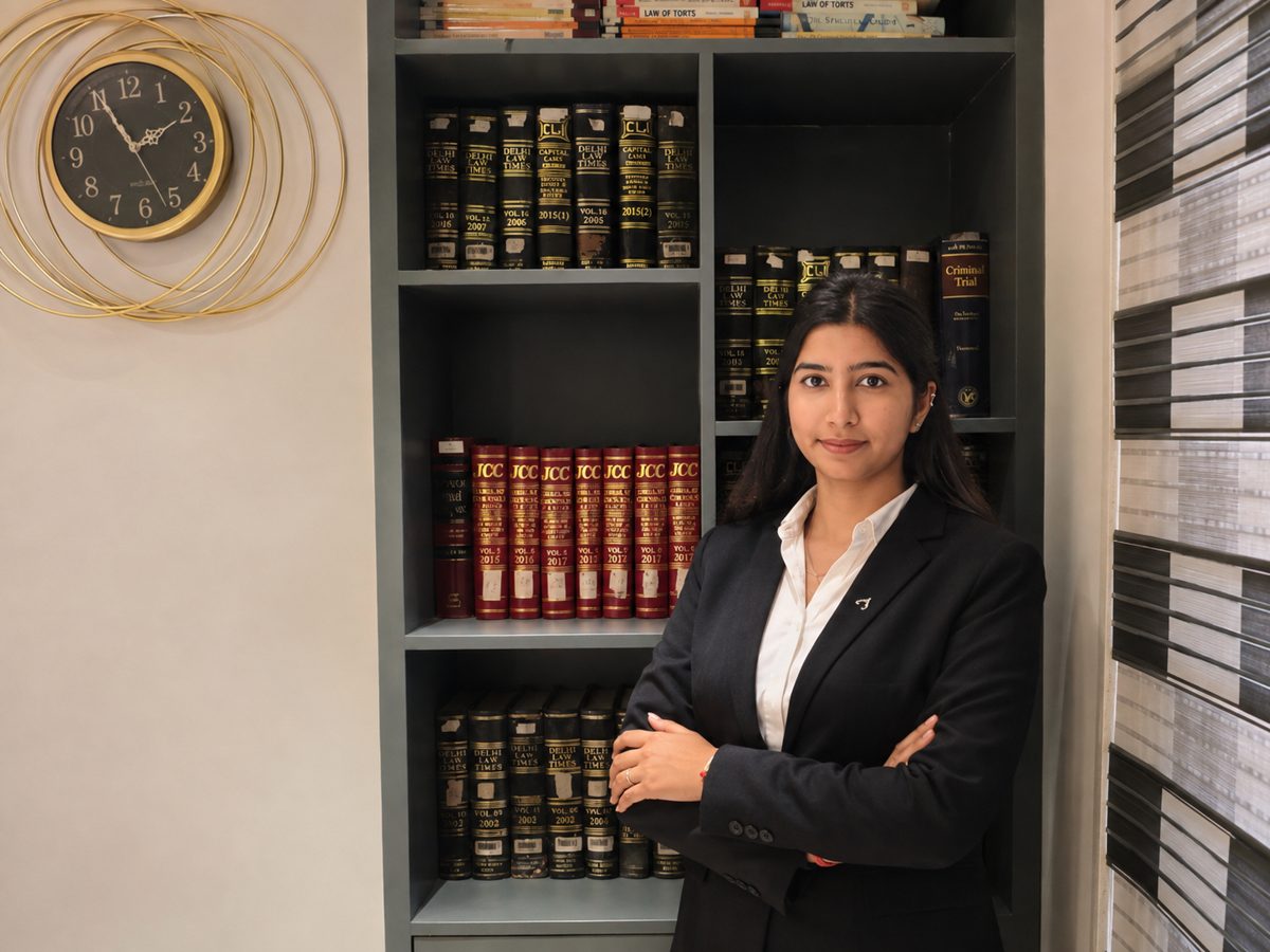 Tanya Vasandani, Advocate at Samvid Law Chambers, standing before the chambers law-reports library in Delhi